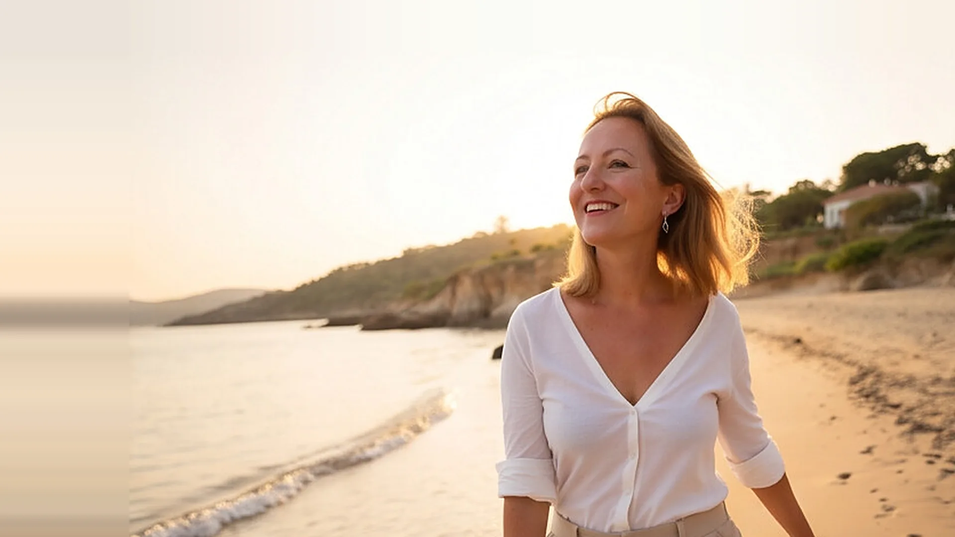 Catherine smiling on a beach in Cyprus at sunset