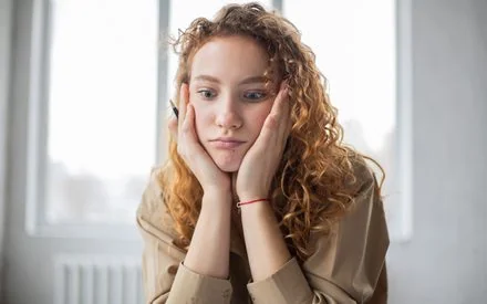 Woman looking withdrawn and low-energy